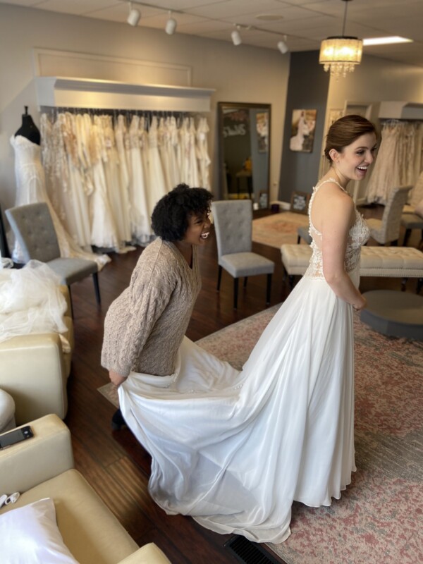 A bride and stylist sharing a moment during a wedding gown appointment